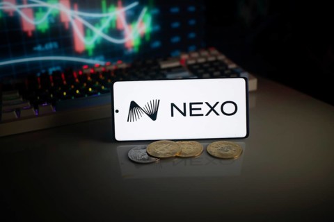 NEXO logo displayed with coins and market graph amid neon lights