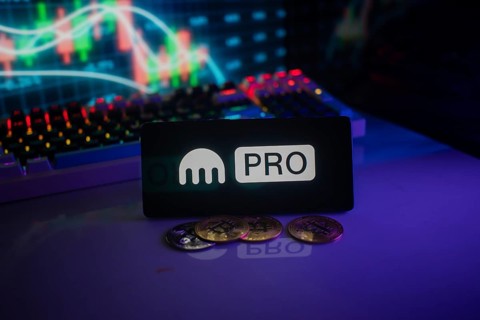 Kraken's PRO logo amid cryptocurrency coins and glowing market graph