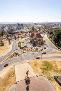 The bronze statue of Dr. Sam Nujoma and Christuskirche is a historic Lutheran church in Windhoek,