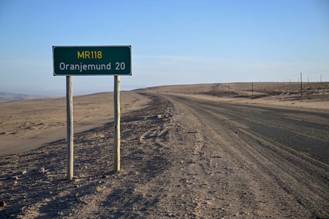 Distance sign near Oranjemund, diamond restricted area, Karas region, Namibia