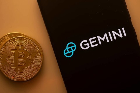 Black Gemini screen and Bitcoin coin, symbolizing cryptocurrency exchange