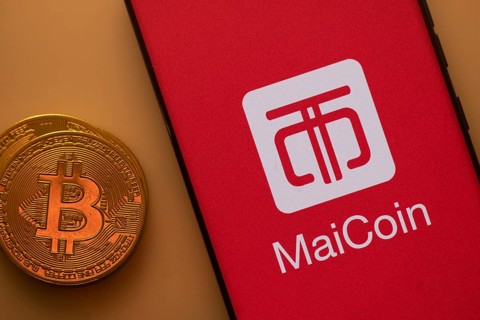 Bitcoin coin next to a smartphone featuring the MaiCoin logo on a red background