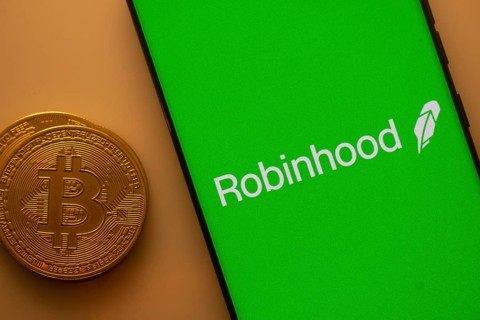 Green Robinhood screen with Bitcoin coin, representing cryptocurrency trading