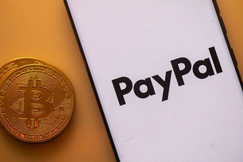 Bitcoin coin beside PayPal logo on a white background, symbolizing digital transactions
