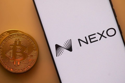 Nexo logo on smartphone screen beside Bitcoin, highlighting financial technology and cryptocurrency