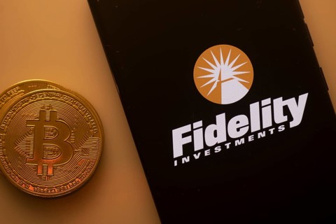 Fidelity Investments logo on phone next to Bitcoin, highlighting financial services and investments