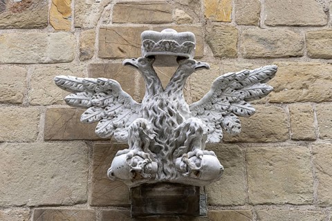 Stone relief of a crowned eagle, symmetrically and artistically embedded in a wall, St.Stephan's