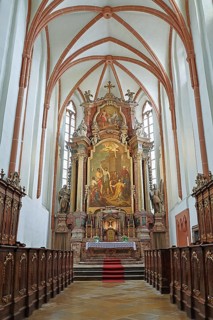 Majestic church altar with detailed woodwork and high ceiling structures, parish church of St