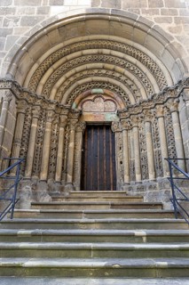 Romanesque stone door, carner with detailed decorations, symmetrically constructed, with stairs,