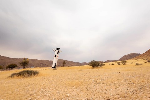A mock Soviet rocket stands nose-first in the Solitaire, Namibian desert, surrounded by golden