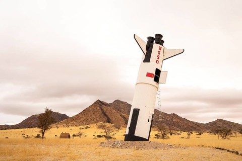 A mock Soviet rocket stands nose-first in the Solitaire, Namibian desert, surrounded by golden
