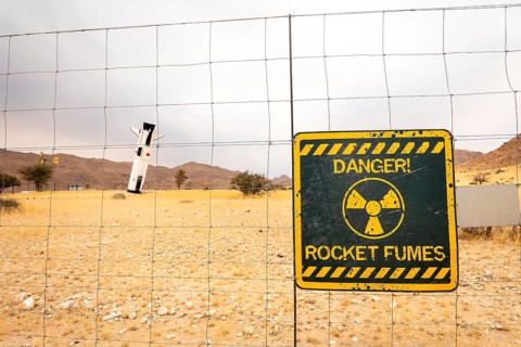 A mock Soviet rocket stands nose-first in the Solitaire, Namibian desert, surrounded by golden