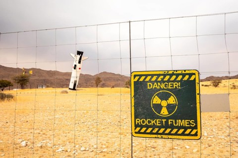 A mock Soviet rocket stands nose-first in the Solitaire, Namibian desert, surrounded by golden