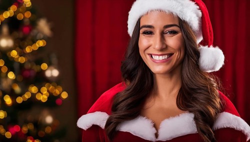 Beautiful smiling woman wearing santa hat posing in front of christmas tree lights, AI generated