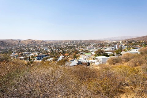 A panoramic view of Windhoek, Namibia, from the National Botanic Garden, showing the city's mix of