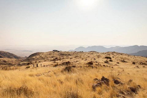 A picnic spot overlooks the vast Namib Desert from Spreetshoogte Pass, with hazy plains, rugged