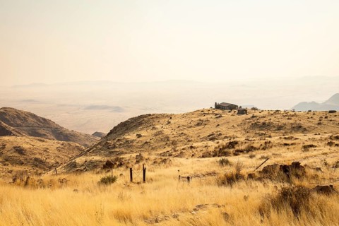 A picnic spot overlooks the vast Namib Desert from Spreetshoogte Pass, with hazy plains, rugged