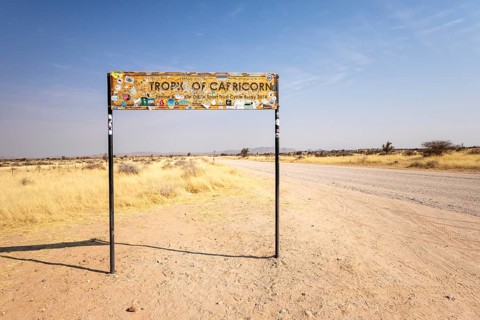 Namibia- 25 August, 2025: Road sign marking the Tropic of Capricorn in Namibia's dry, sandy