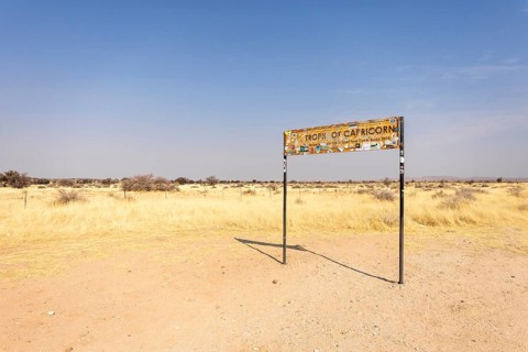Namibia- 25 August, 2025: Road sign marking the Tropic of Capricorn in Namibia's dry, sandy