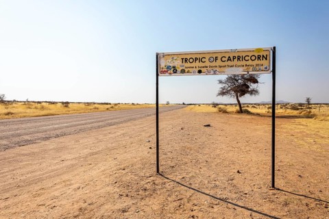 Namibia- 25 August, 2025: Road sign marking the Tropic of Capricorn in Namibia's dry, sandy