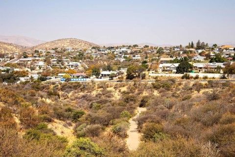 A panoramic view of Windhoek, Namibia, from the National Botanic Garden, showing the city's mix of