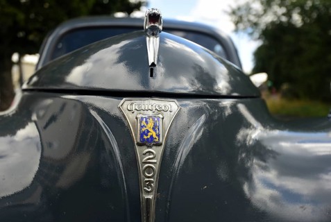 Front view of a vintage Peugeot 203, seen at a company anniversary of Energie-Mann in Westerwald