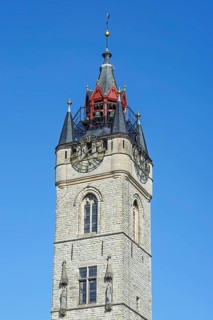 Close-up of 14th century Gothic belfry tower with carillon and clock in the historic city centre of