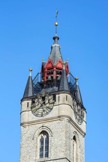 Close-up of 14th century Gothic belfry tower with carillon and clock in the historic city centre of