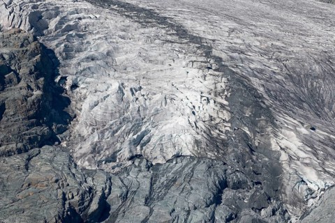 Impressive scene shows lines and textures on residual ice cream in mountains. Daylight emphasises