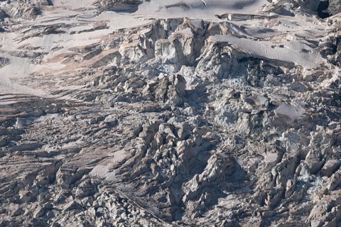 Impressive scene shows lines and textures on residual ice cream in mountains. Daylight emphasises