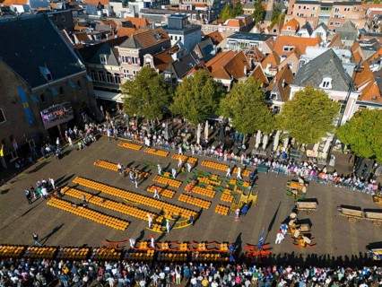 Aerial view of a busy marketplace with orange cheese and people, aerial view, cheese, cheese