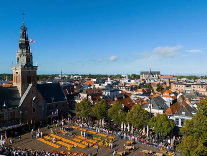 View over town with church and market square, surrounded by historic buildings, aerial view,
