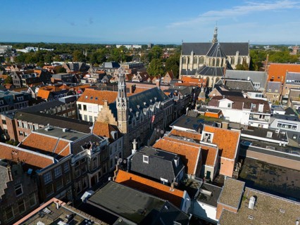 Aerial view of a city with historic buildings and a church under a clear sky, aerial view, town