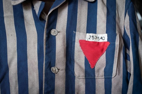 Copy of a blue and grey striped jacket of a concentration camp prisoner with a sewn-on number and