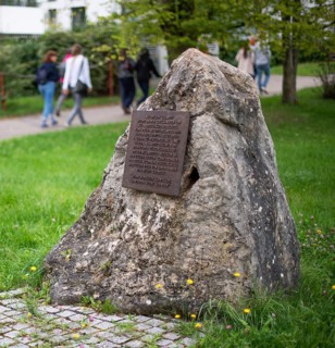 Stone with memorial plaque commemorating forced labourers and prisoners in concentration camp