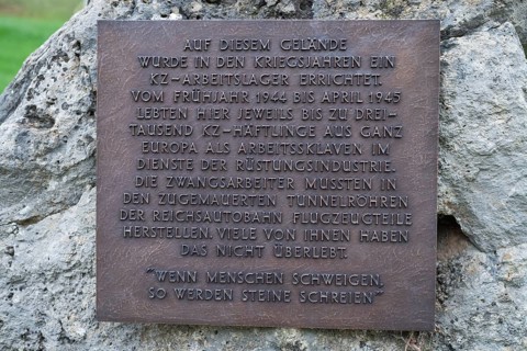 Stone with memorial plaque commemorating forced labourers and prisoners in concentration camp