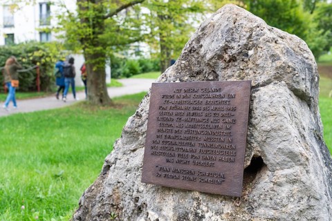 Stone with memorial plaque commemorating forced labourers and prisoners in concentration camp