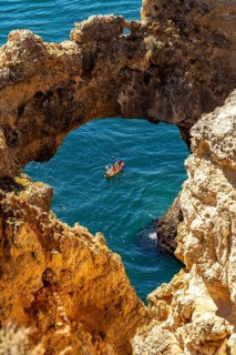 Excursion boats at the caves and rocky gates of the Ponta da Piedade rocky coast, rugged coastal