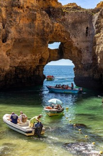 Excursion boats at the caves and rocky gates of the Ponta da Piedade rocky coast, rugged coastal