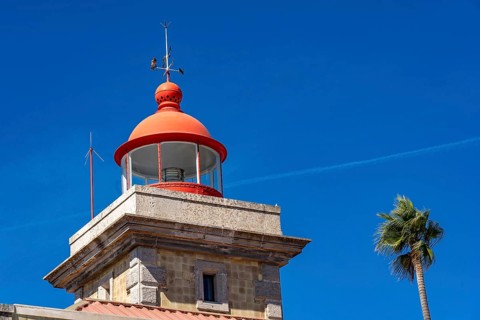 Ponta da Piedade lighthouse on the Ponta da Piedade rocky coast, rugged coastal landscape, right