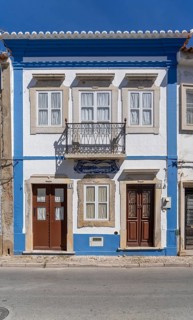 Facade of buildings decorated with tiles, azulejos, coloured tiles on facades, in Tavira, old town,