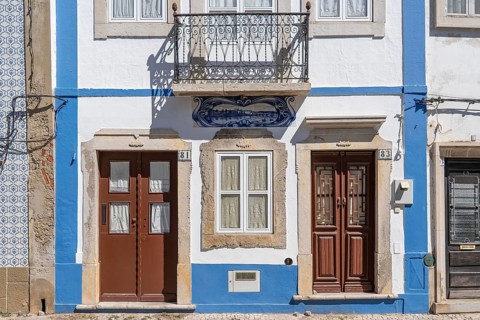 Facade of buildings decorated with tiles, azulejos, coloured tiles on facades, in Tavira, old town,