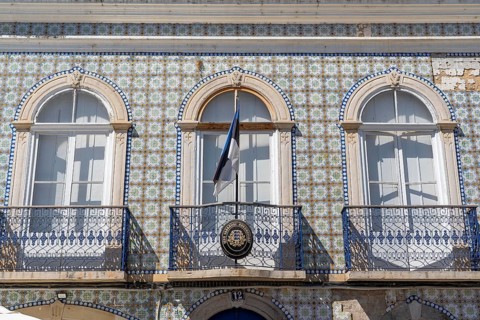 Facade of buildings decorated with tiles, azulejos, coloured tiles on facades, in Tavira, old town,