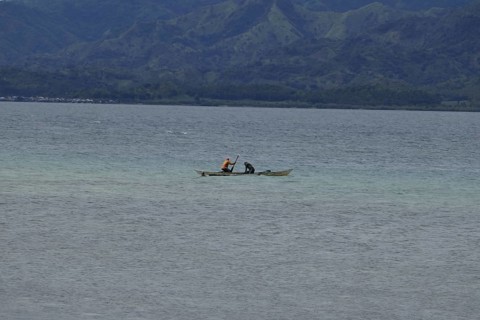 Two fishermen fishing off the coast, Negros Occidental, Philippines