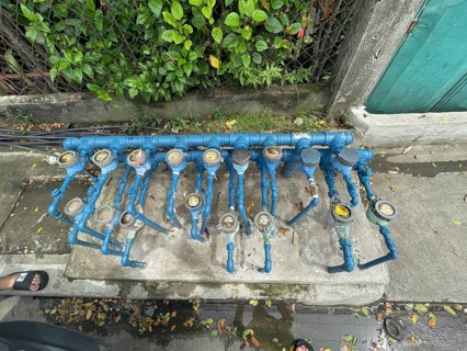 Infrastructure, water pipes and water meters of various houses, San Carlos, Negros Occidental,