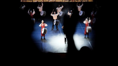 Dozens of members of Fire of Anatolia perform a drumming sequence during a cultural festival at
