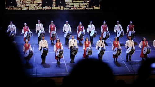 Dozens of members of Fire of Anatolia perform a drumming sequence during a cultural festival at