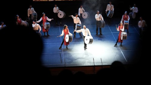Dozens of members of Fire of Anatolia perform a drumming sequence during a cultural festival at