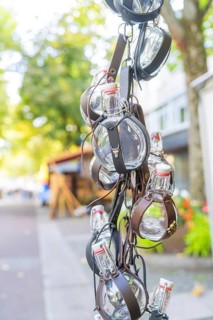 Leather-wrapped bottles hanging decoratively from a stall at a market, Sindelfingen, Böblingen