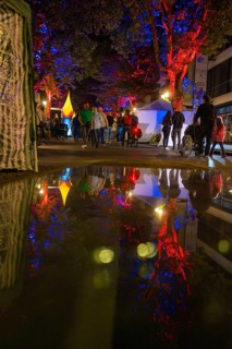 Colourful night lights reflected in a rain-soaked street during an event, Sindelfingen, Böblingen